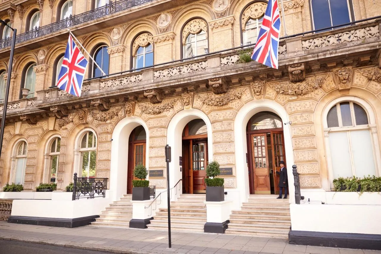 two british flags flying in front of a building at The Clermont London, Victoria in London