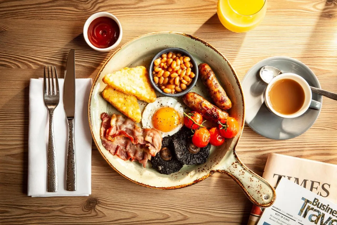 a breakfast of eggs bacon beans and toast and coffee at The Clermont London, Victoria in London