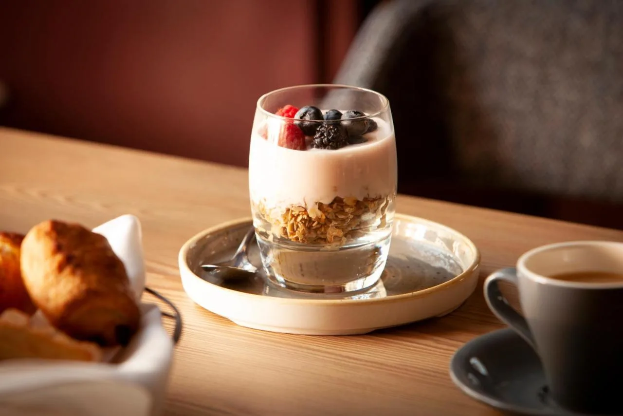 a dessert with berries in a glass on a table at The Clermont London, Victoria in London